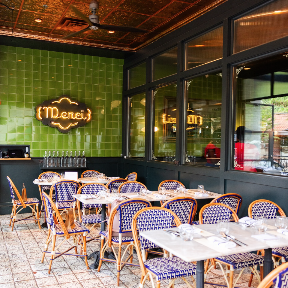 bread and butterfly restaurant in atlanta - outdoor / patio dining. with a Merci sign on wall