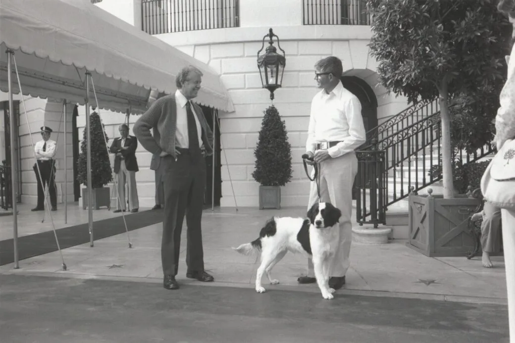 Former president Jimmy Carter and his dog grits outside