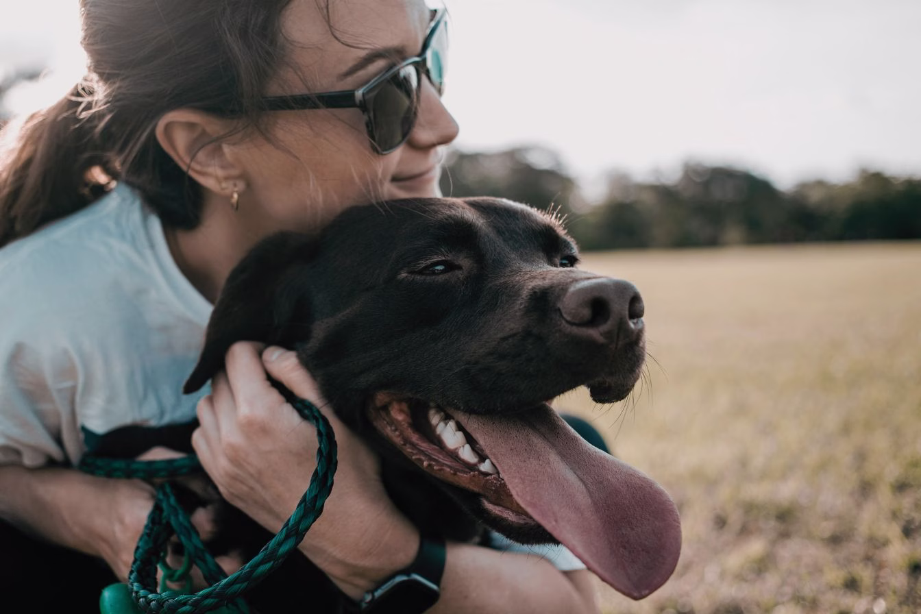 woman and black lab dog