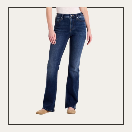 woman wearing bootcut jeans and a white shirt